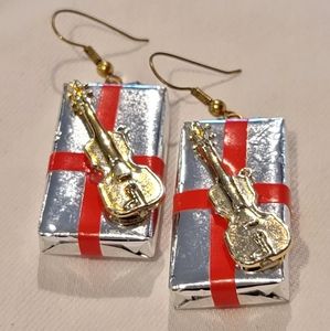 Christmas present earrings with violin on top.